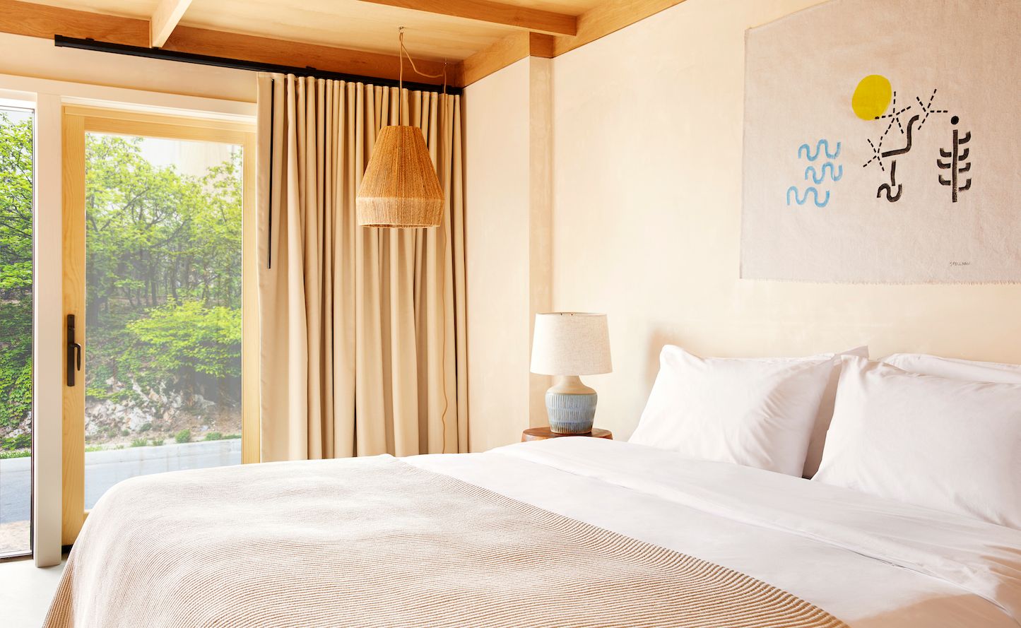 A king bed, a curtain, a glass door, a patio