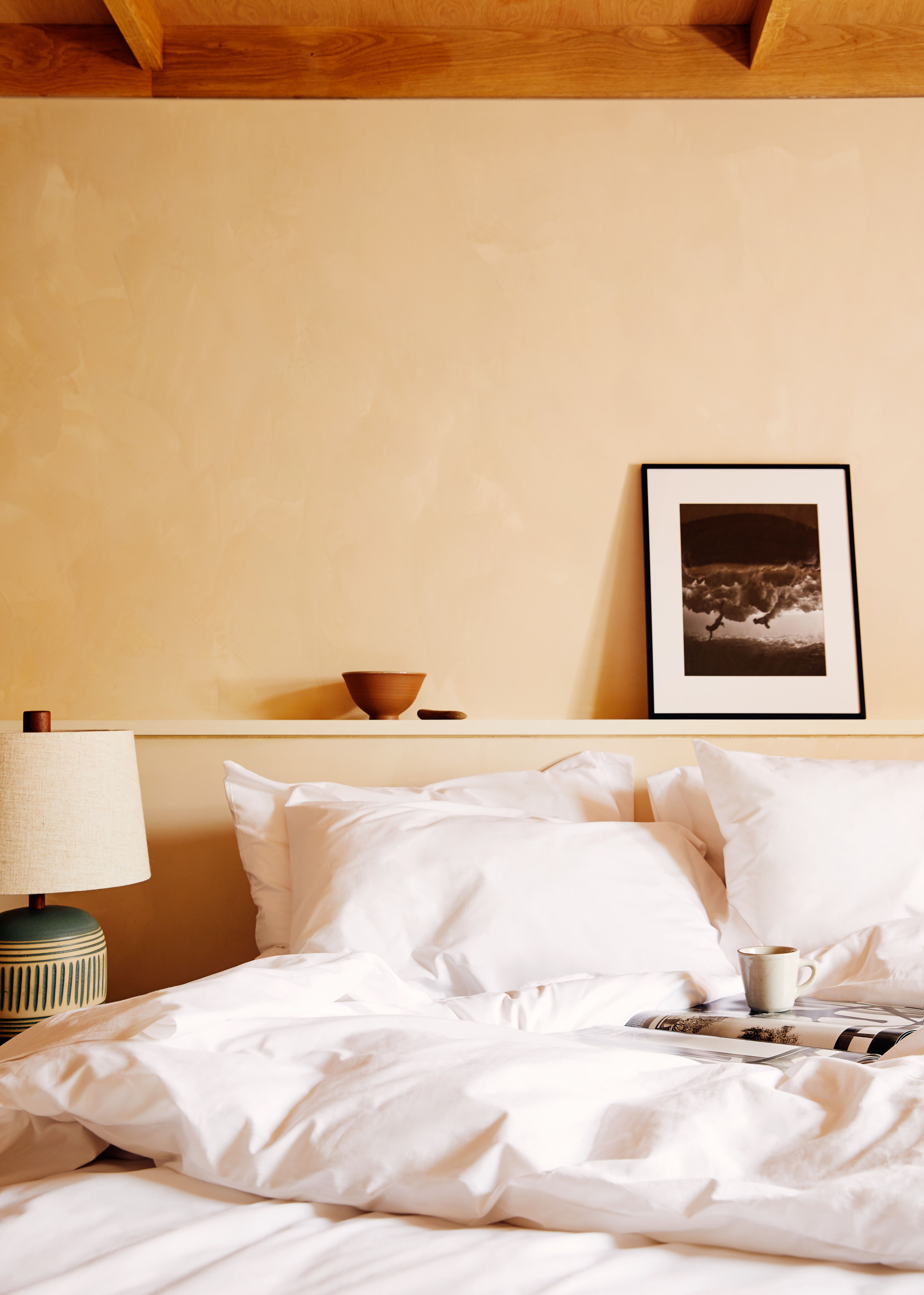 A patio with chairs and a table next to dune grass