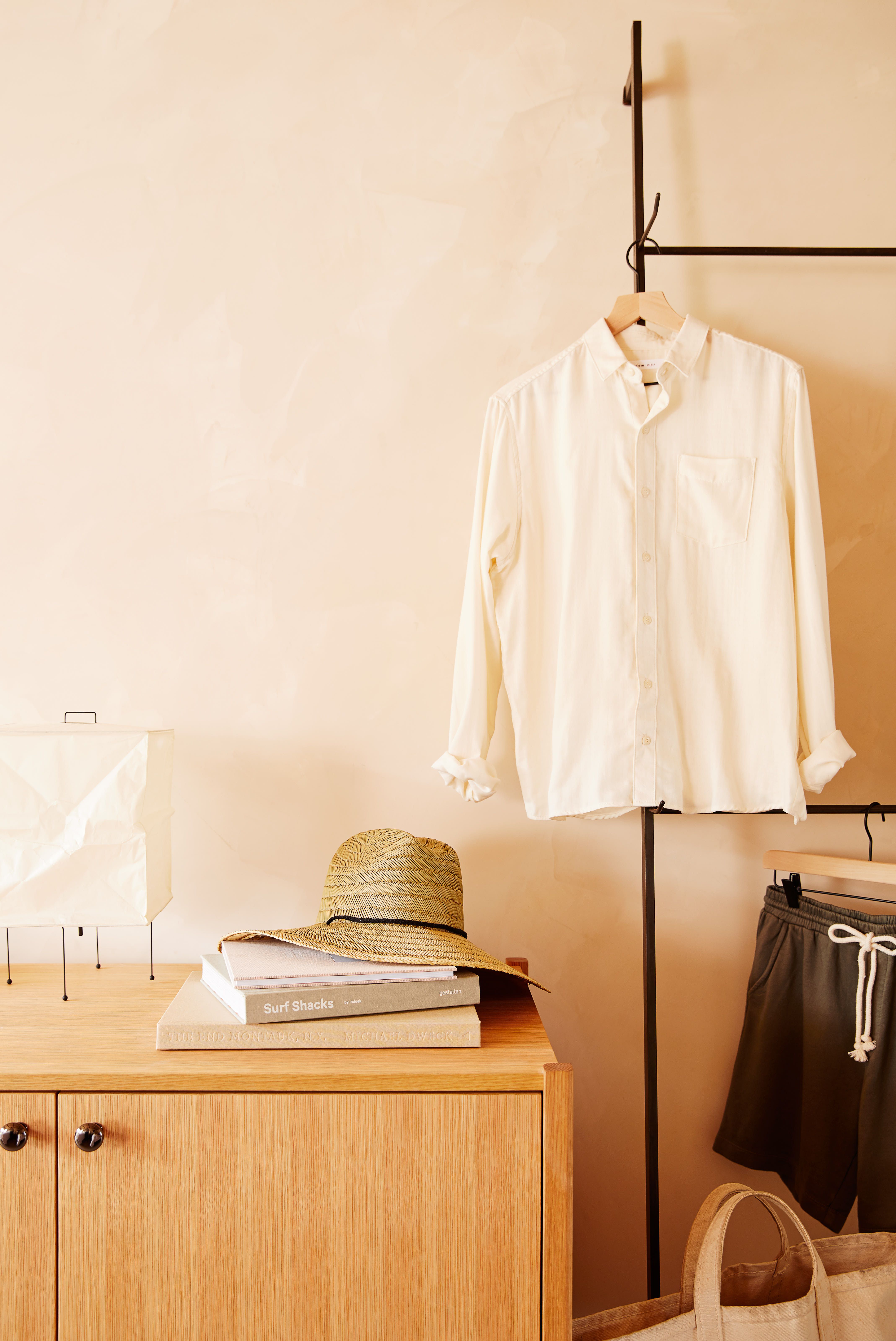 A patio with chairs and a table next to dune grass