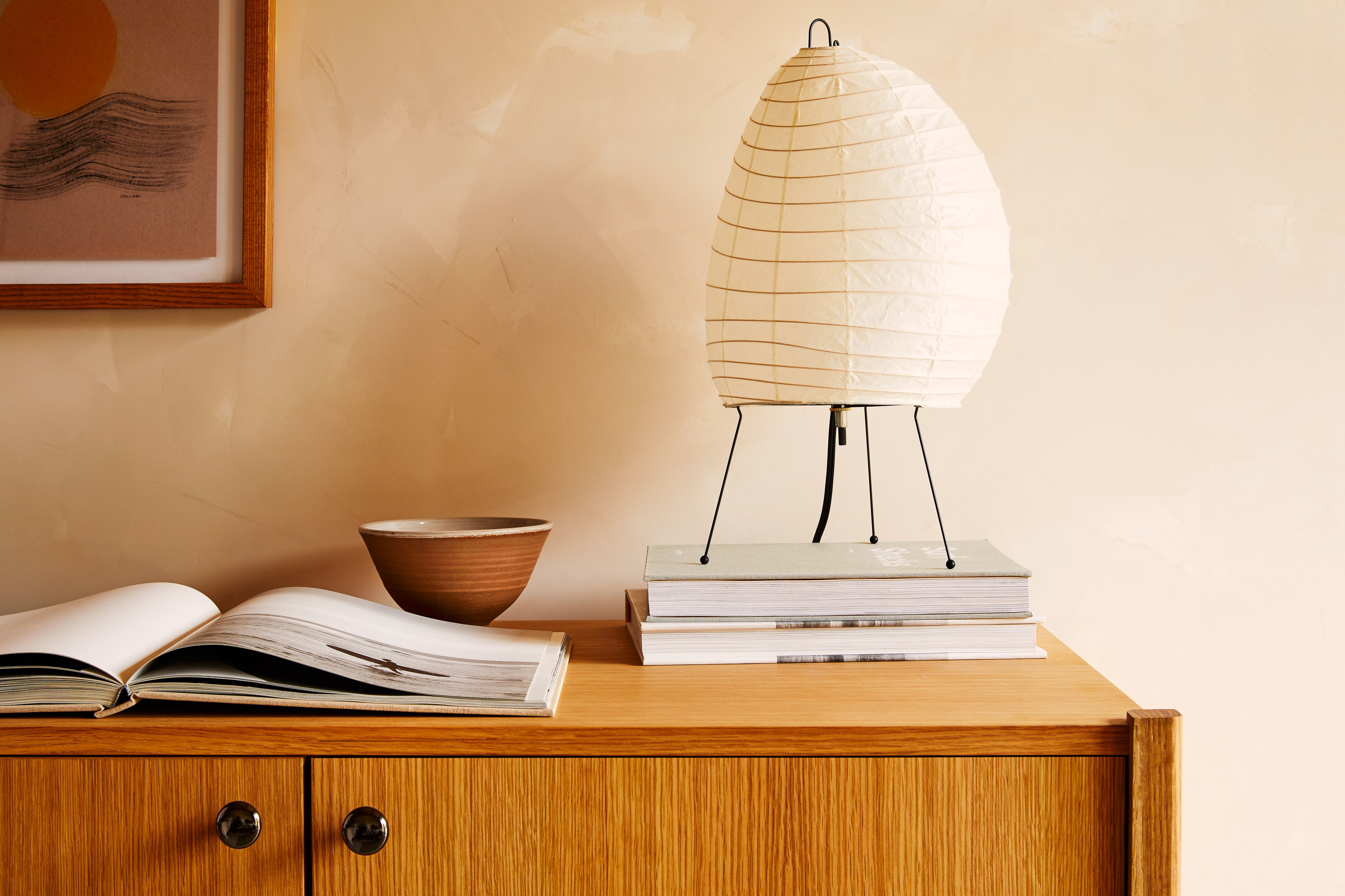Clothes hanging on an iron rack in a lit room