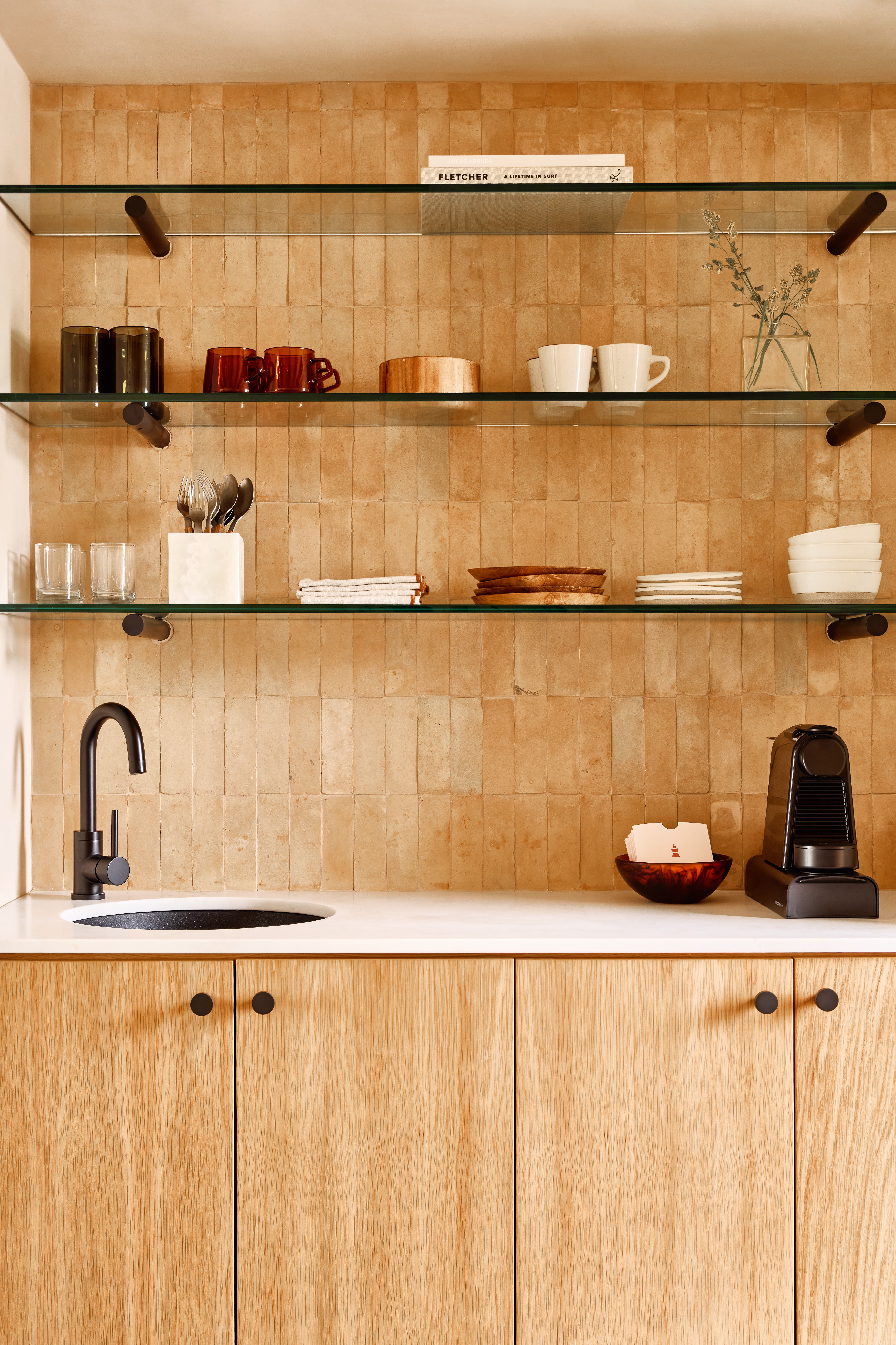 A patio with chairs and a table next to dune grass