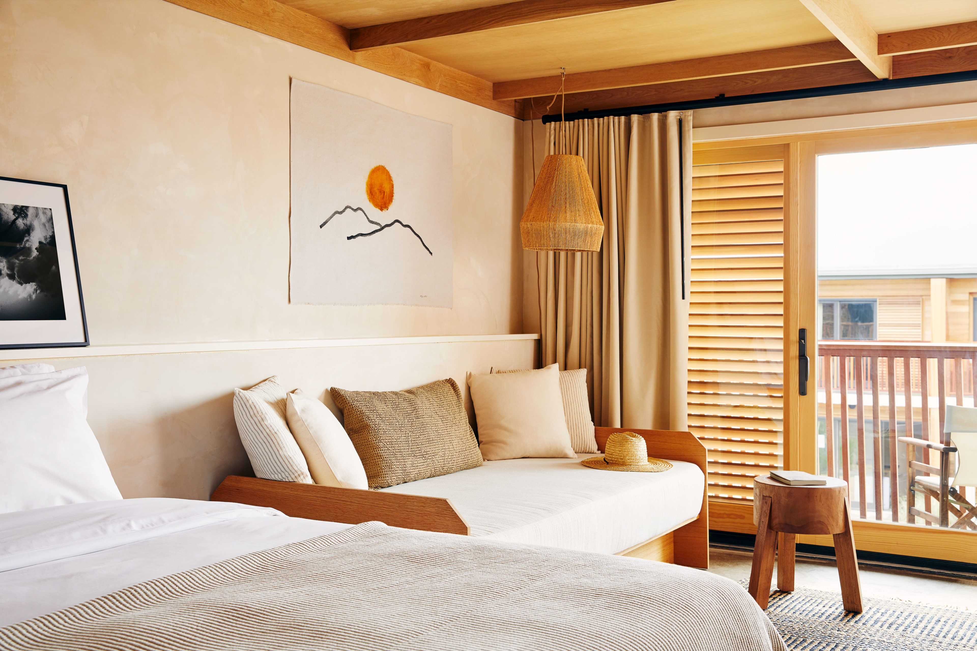 A bed and a daybed in a well furnished room