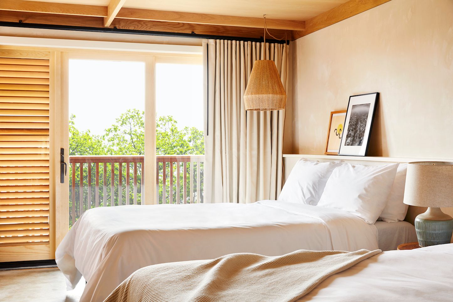 Two queen beds, a curtain, glass doors, a patio