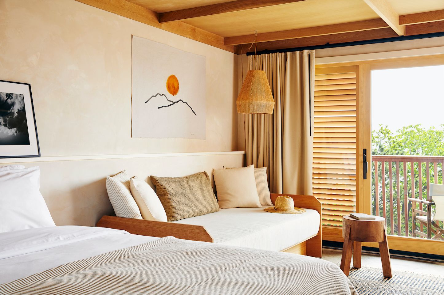 A king bed, a daybed, a curtain, a glass door, a patio