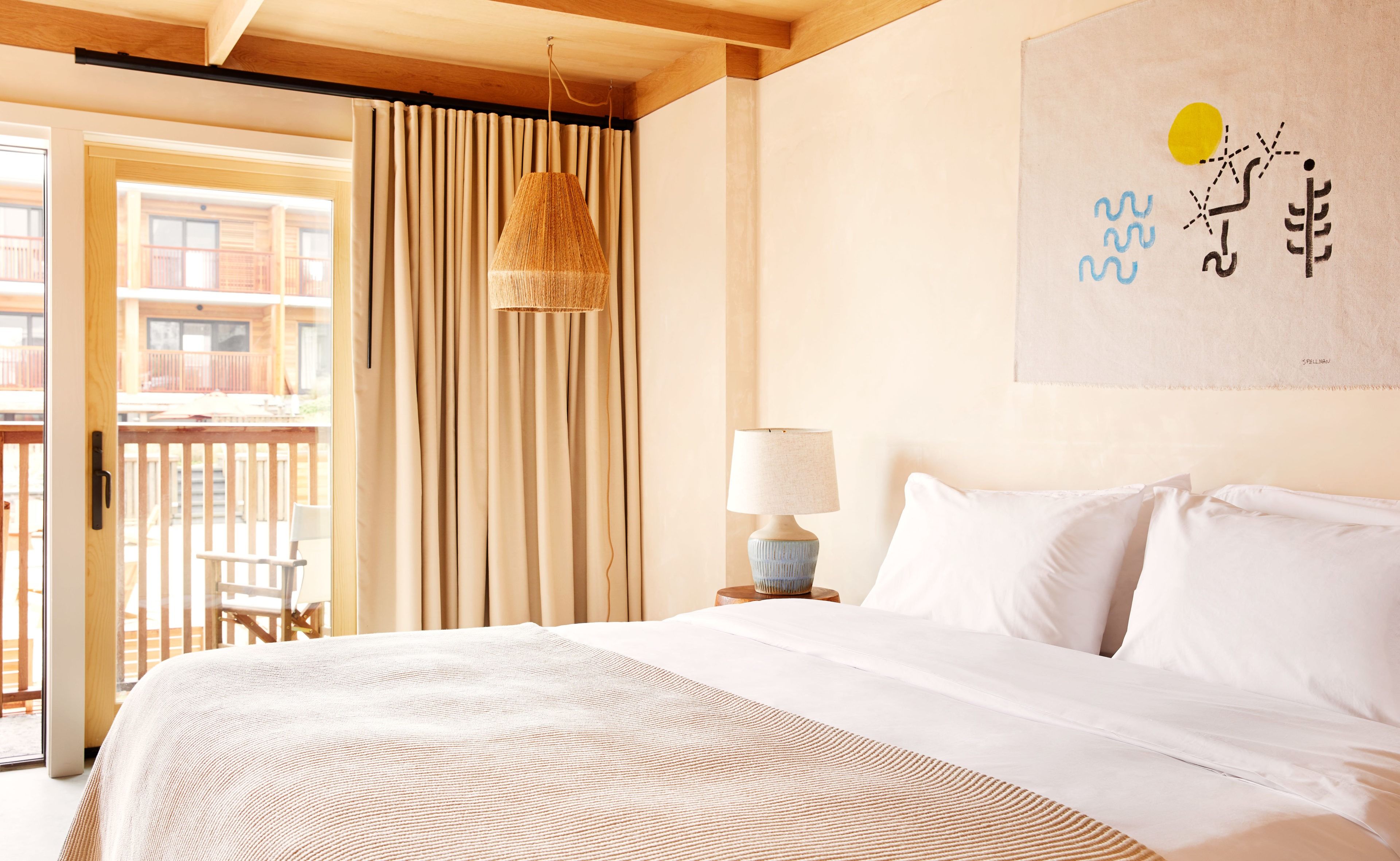 A king bed, a curtain, a glass door, a patio